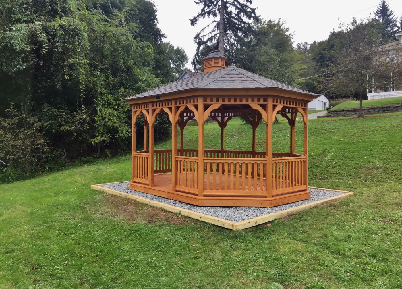 Wood oval gazebo in a garden setting by Waterloo Products serving New Jersey and Maryland